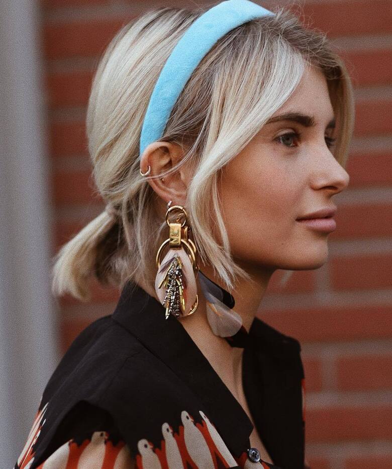 hair accessory headband aqua gold earrings feathers black shirt